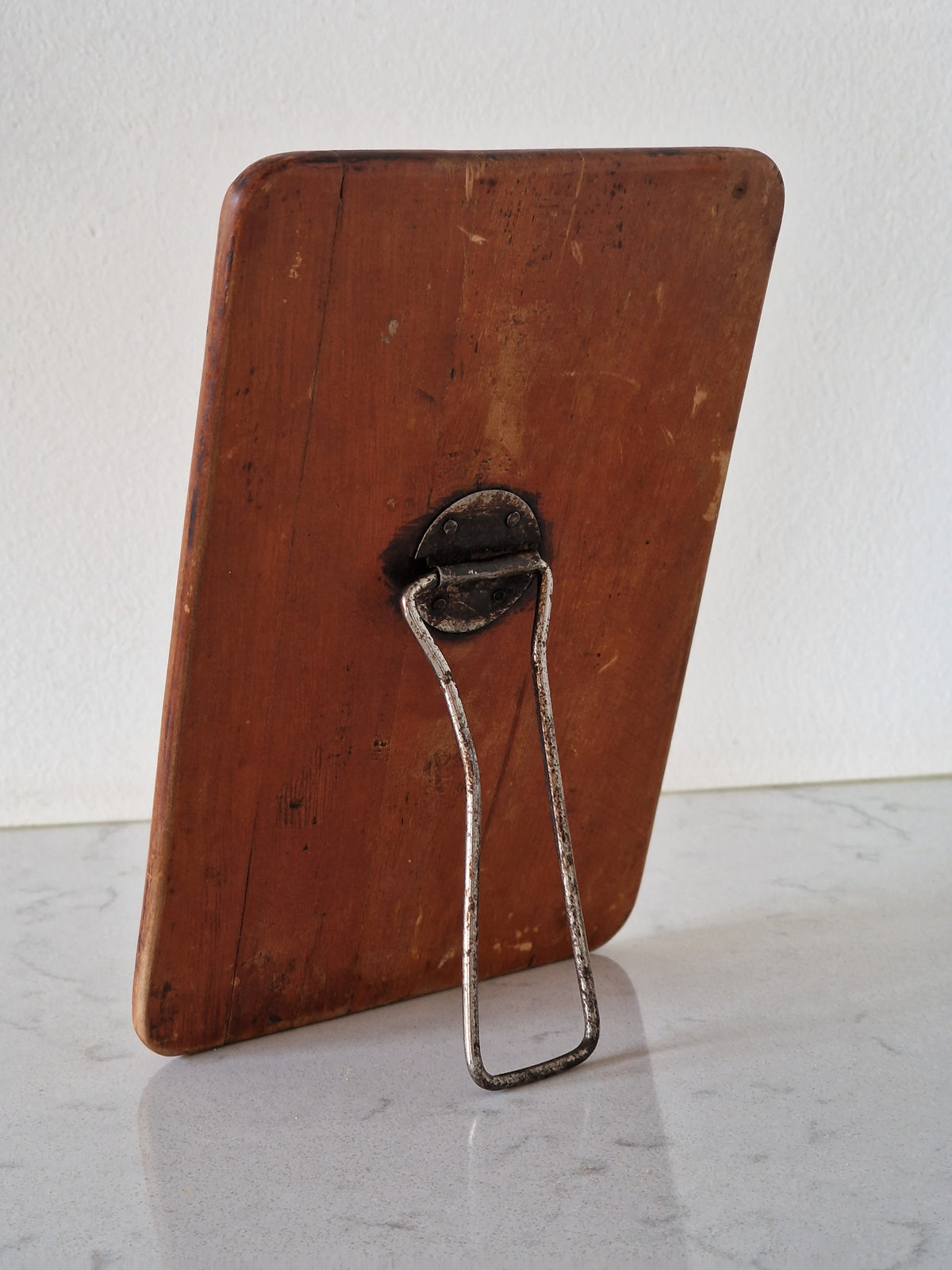 An old mirror with a wooden frame