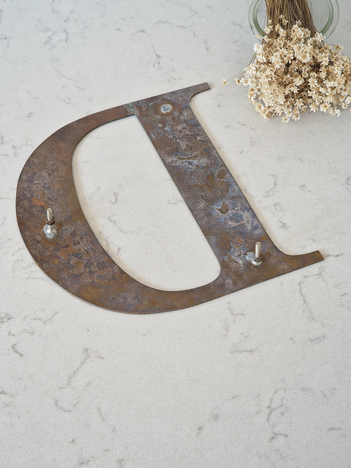 Brass letter D
