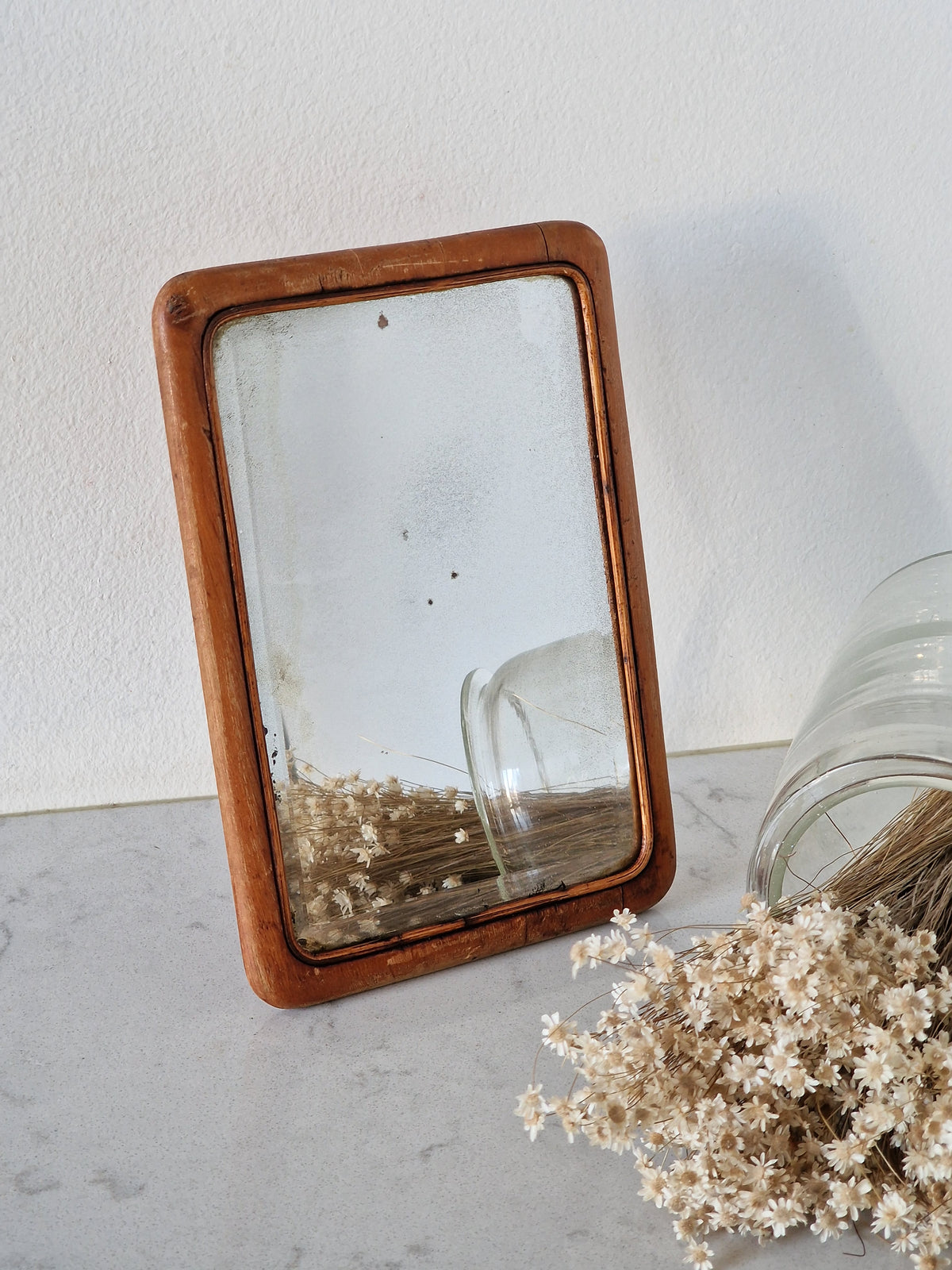 An old mirror with a wooden frame