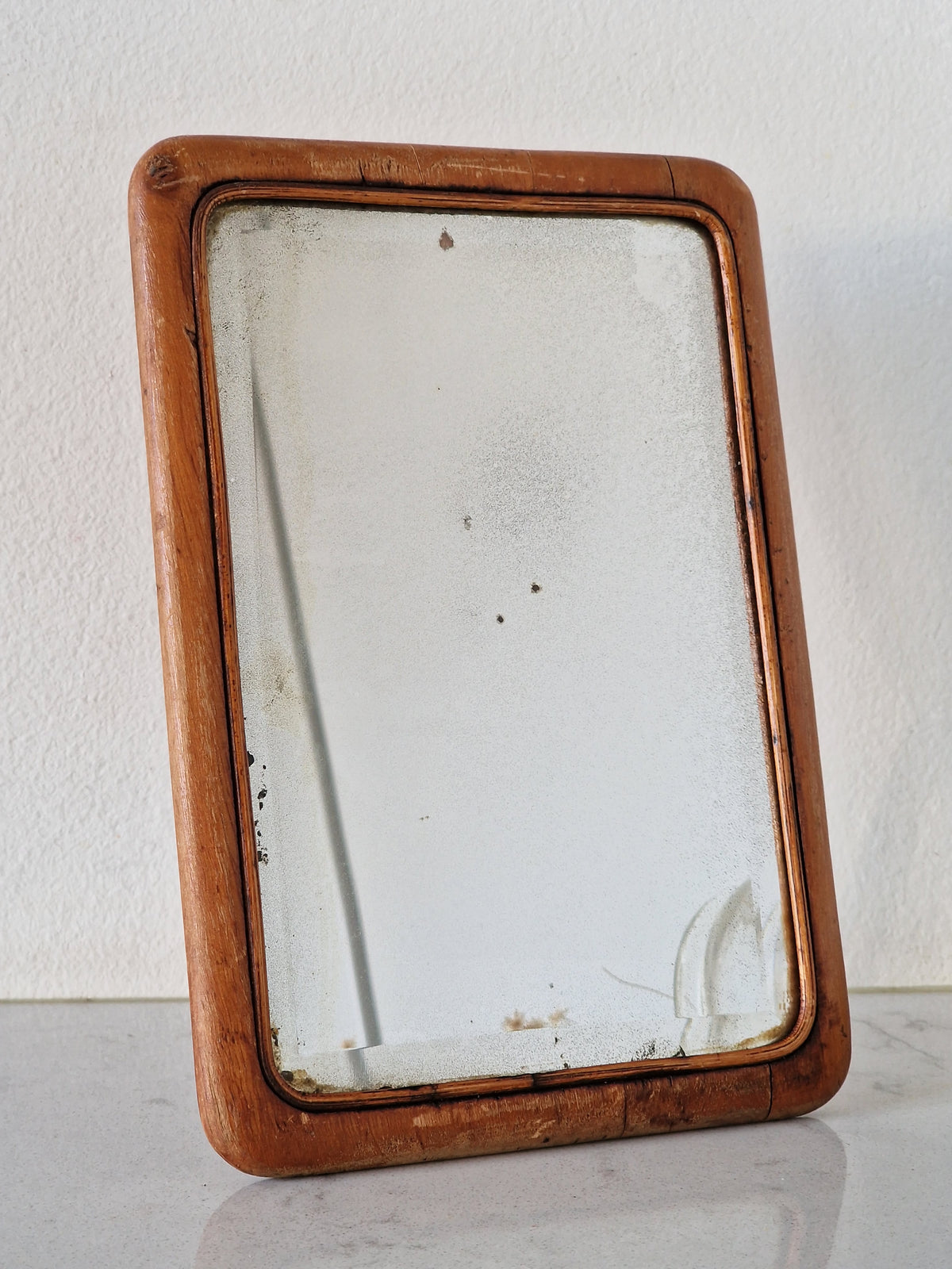 An old mirror with a wooden frame