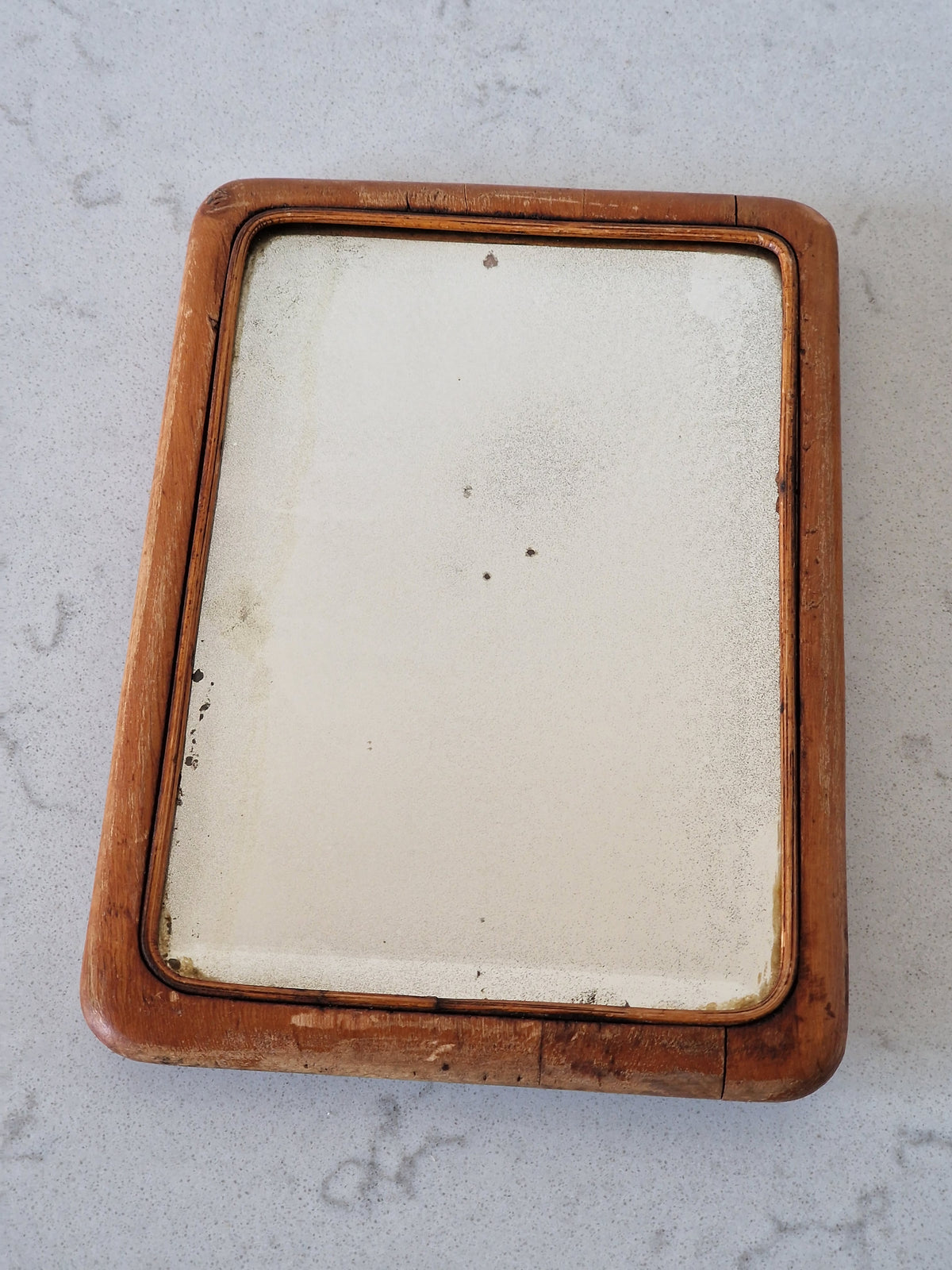 An old mirror with a wooden frame