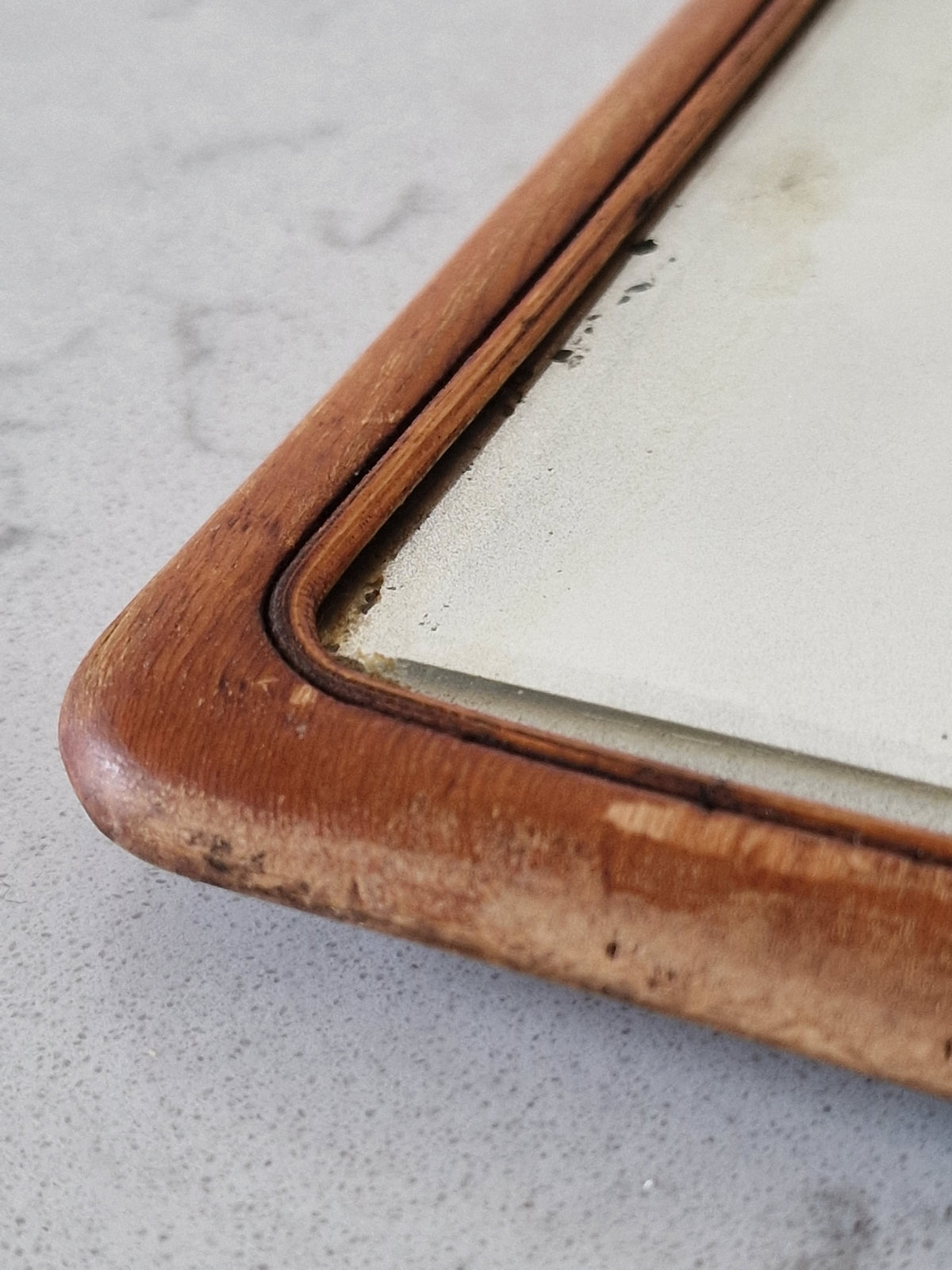 An old mirror with a wooden frame