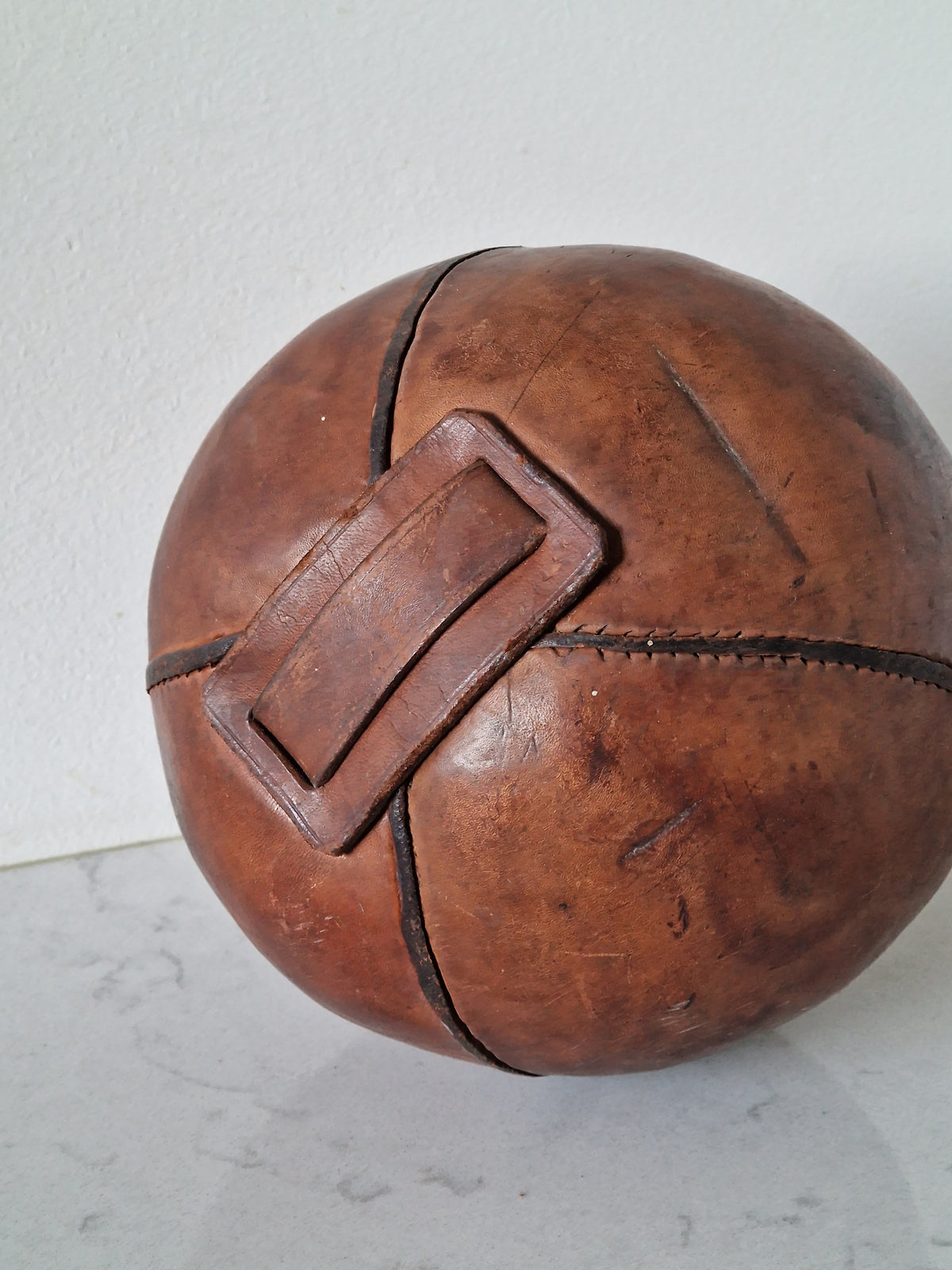 Vintage fitness ball with leather straps